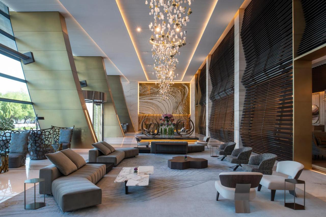 Steigenberger Hotel Doha Exterior photo The photo depicts a modern and stylish hotel lobby. It features a spacious interior with elegant design elements. Prominent highlights include:

- A large, artistic chandelier hanging from the ceiling, providing ambient lighting.
- A central seating 