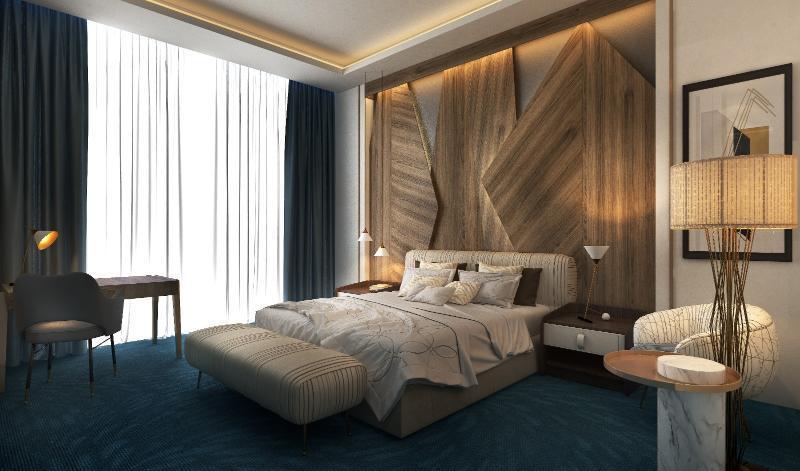 Steigenberger Hotel Doha Exterior photo The photo shows a modern bedroom with a stylish and contemporary design. The room features a large bed with a textured headboard, complemented by plush bedding. There are two bedside lamps on either side of the bed, and a small seating area with an u